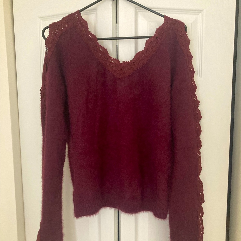 Burgundy thick sweater with lace trim.